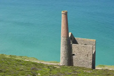 a tower on top of a hill next to the water at Sea Gem in St. Agnes