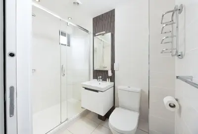 a bathroom with a toilet and a sink and a shower at Sea Gem in St. Agnes