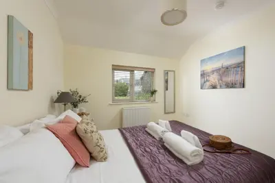 a bedroom with a large bed with towels on it at September Sea in Port Isaac