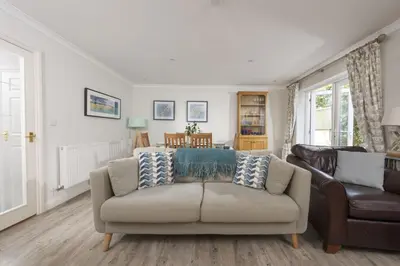 a living room with a couch and a chair at September Sea in Port Isaac