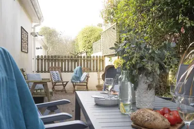 a table with a plate of food on a patio at September Sea in Port Isaac