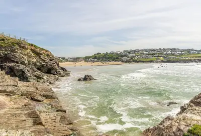 a view of a beach with people in the water at September Sea in Port Isaac