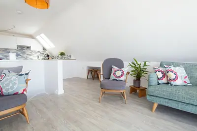 a living room with two chairs and a couch at Sunfish in Porthtowan