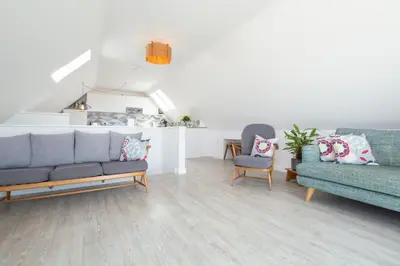 a living room with two couches and two chairs at Sunfish in Porthtowan