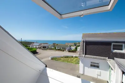 a view of the ocean from the balcony of a house at Sunfish in Porthtowan
