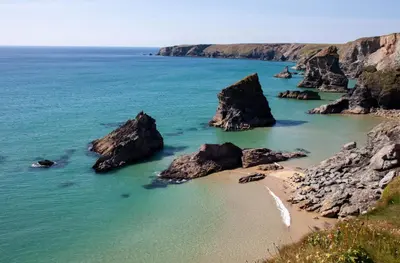 a view of a beach with rocks in the water at Sunfish in Porthtowan