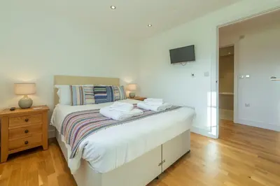 a bedroom with a bed with two towels on it at Stargazy in St. Agnes