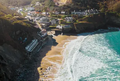 an aerial view of a beach with houses and the ocean at Stargazy in St. Agnes