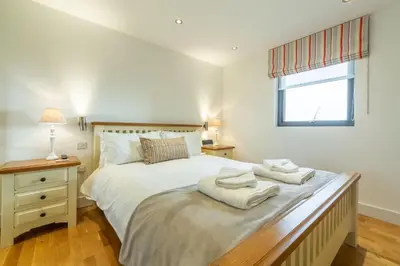 a bedroom with a bed with two towels on it at Stargazy in St. Agnes