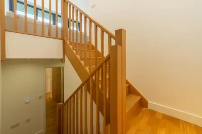 a staircase in a house with wooden floors at Teyr Mor Cliff in St. Agnes