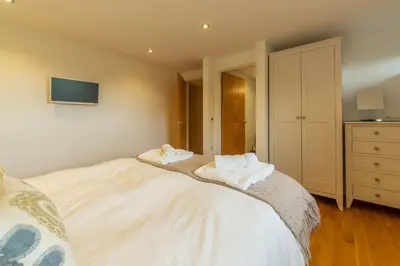 a bedroom with a bed with two towels on it at Teyr Mor Cliff in St. Agnes