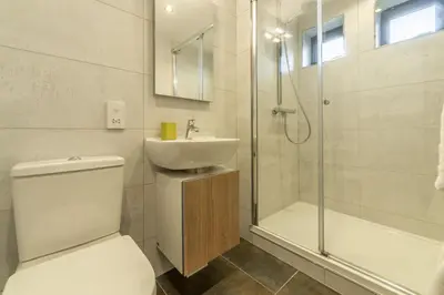 a bathroom with a toilet and a sink and a shower at Teyr Mor Cliff in St. Agnes