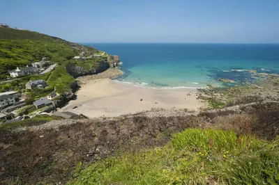 a view of a beach with people in the water at Teyr Mor Cliff in St. Agnes