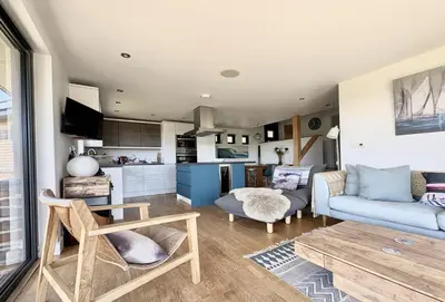 a living room with a couch and a table at The Deck House in St. Agnes