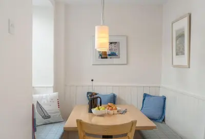 a dining room table with a bowl of fruit on it at The Boy's Cottage in Portreath