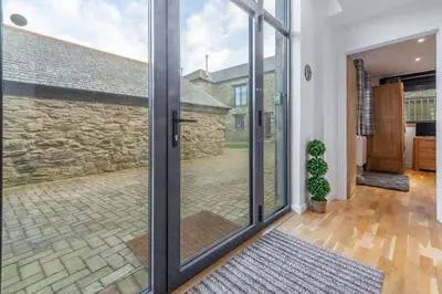 a sliding glass door in a home with a courtyard at The Shires in St. Agnes