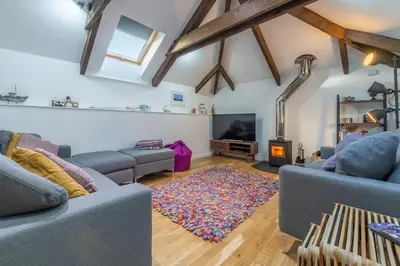 a living room with two couches and a tv at The Shires in St. Agnes