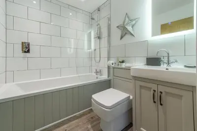 a bathroom with a toilet and a sink and a tub at The Shires in St. Agnes