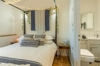a bedroom with a bed with pillows on it at The Stables in St. Agnes