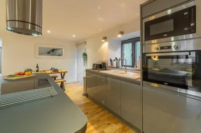 a kitchen with a large stainless steel appliance at The Stables in St. Agnes