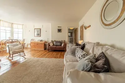 a living room with a couch and a table at The Watch House in Helston