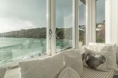 a window seat with a view of the ocean at The Watch House in Helston