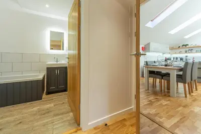 a kitchen and dining room with a dining table at The Parlour in St. Agnes