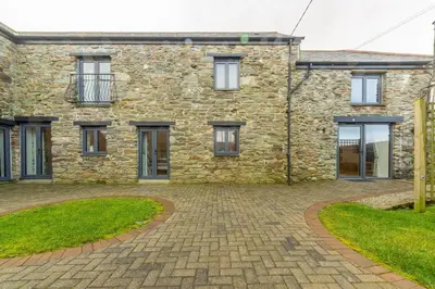 a stone house with a brick driveway at The Parlour in St. Agnes