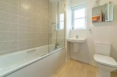a bathroom with a toilet and a sink and a shower at The Seahouse in Portreath