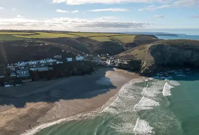 an aerial view of a beach with houses and the ocean at Westaway in Portreath