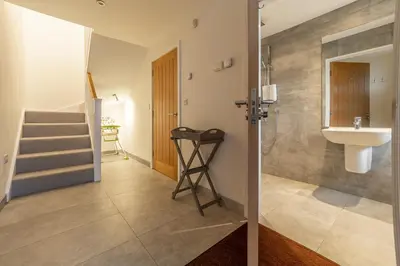 a bathroom with a sink and a toilet and a staircase at Westaway in Portreath