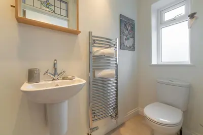 a bathroom with a sink and a toilet and a window at Westerley in Portreath