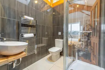 a bathroom with a toilet and a sink and a shower at Westerley in Portreath
