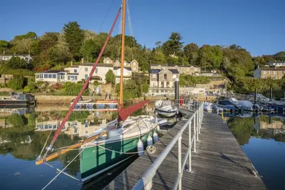 a sailboat docked at a dock in a marina at Waterfront House in Saint Clement