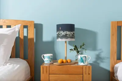 a table with fruit on it next to a bed at Wavelength in St. Agnes