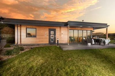 a modular home with a patio and a dining area at Wavelength in St. Agnes