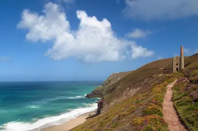 a path on a hill next to the ocean at Wavelength in St. Agnes