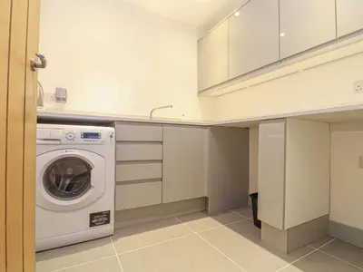 a laundry room with a washing machine in it at Idlewild, 2 Wheal Turnavore in St. Agnes