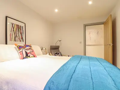 a bedroom with a large white bed in a room at Idlewild, 2 Wheal Turnavore in St. Agnes