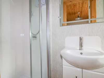 a bathroom with a sink and a shower at Lodge Two in Truro