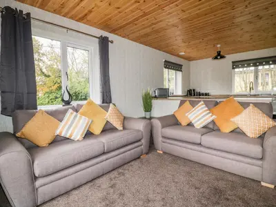 a living room with two couches with pillows on them at Lodge Two in Truro