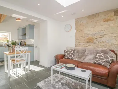 a living room with a couch and a table at The Bull Pen in St Austell