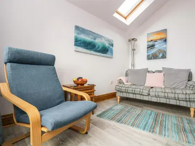 a living room with a chair and a couch at Glenhaven in Tintagel