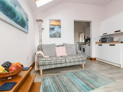 a living room with a couch and a table at Glenhaven in Tintagel