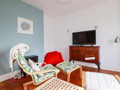 a living room with two chairs and a tv at Wisteria in St Austell