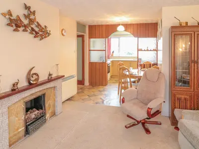 a living room with a chair and a fireplace at Underlanes in Camelford