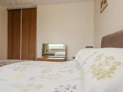 a bedroom with a bed and a mirror at Underlanes in Camelford
