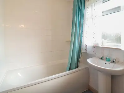 a bathroom with a tub and a sink and a shower at Underlanes in Camelford