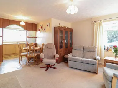 a living room with a table and chairs and a dining room at Underlanes in Camelford