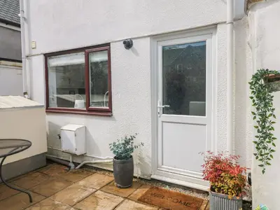 a white door of a house with a window at Riversdale Cottage in Wadebridge